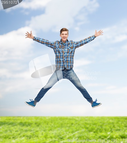 Image of smiling young man jumping in air