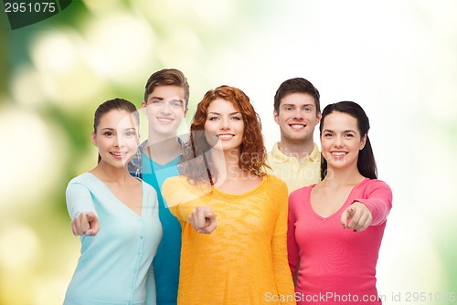 Image of group of smiling teenagers over green background