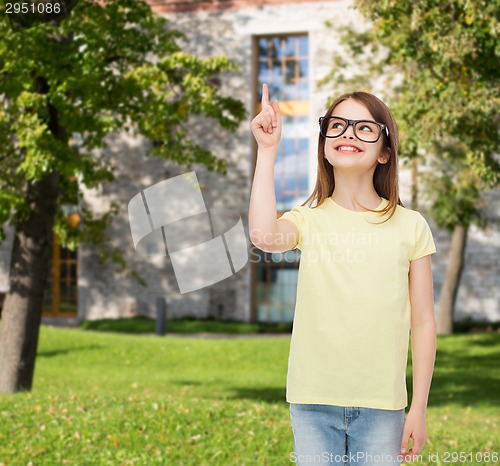 Image of smiling cute little girl in black eyeglasses