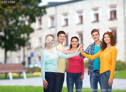 Image of group of smiling teenagers over campus background