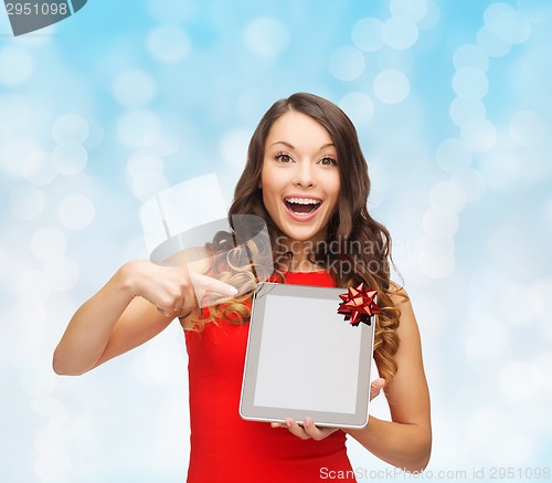 Image of smiling woman in red dress with tablet pc