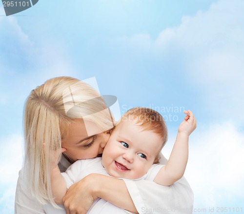 Image of happy mother kissing smiling baby