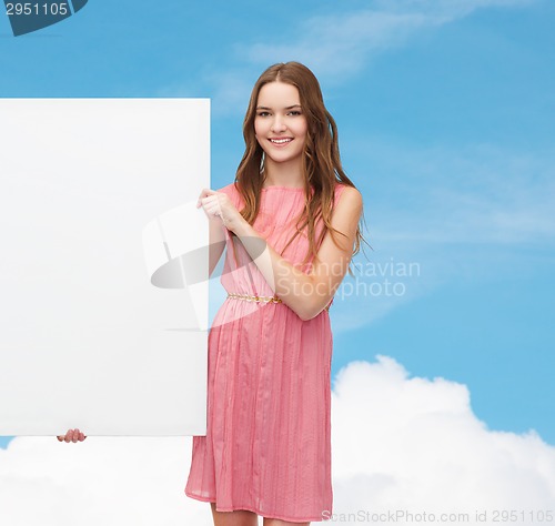 Image of young woman in dress with white blank board