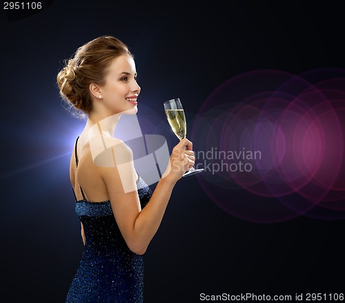 Image of smiling woman holding glass of sparkling wine