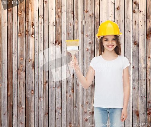 Image of smiling little girl in helmet with paint brush