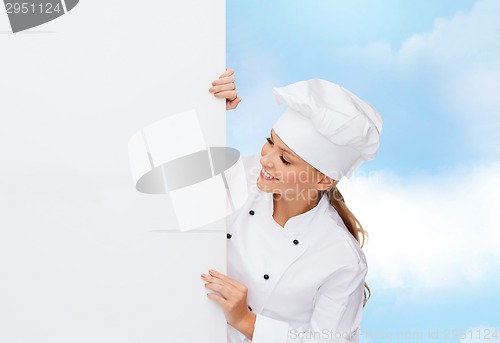 Image of smiling female chef with white blank board