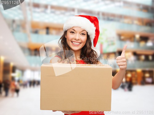 Image of smiling woman in santa helper hat with parcel box