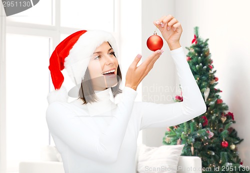 Image of woman in santa helper hat with christmas ball