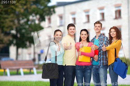 Image of group of smiling teenagers showing thumbs up