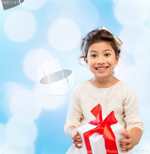 Image of smiling little girl with gift box