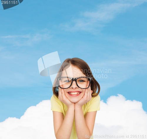 Image of smiling cute little girl in black eyeglasses