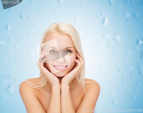 Image of beautiful woman touching her face skin