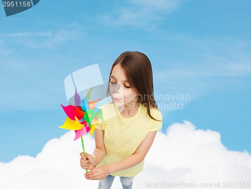 Image of smiling child with colorful windmill toy