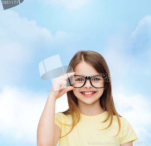 Image of smiling cute little girl in black eyeglasses