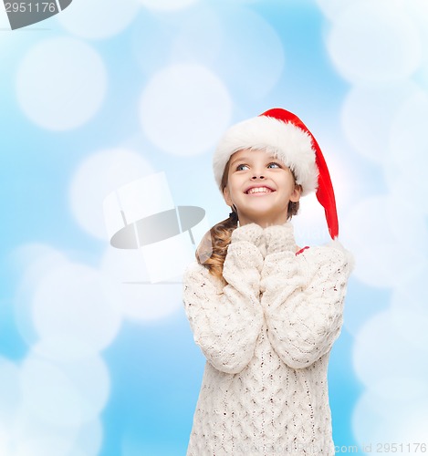 Image of dreaming girl in santa helper hat