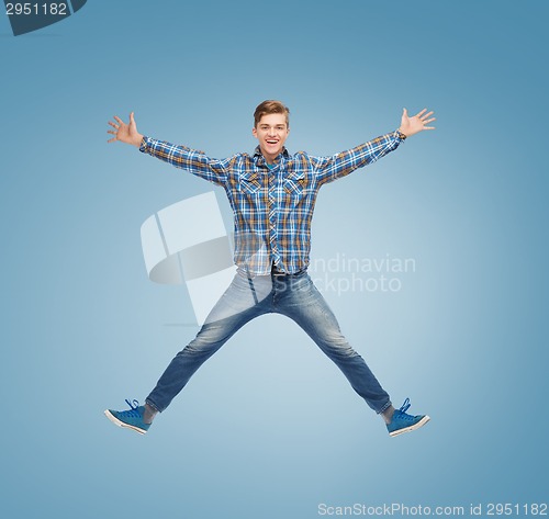 Image of smiling young man jumping in air