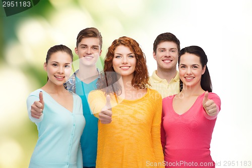 Image of group of smiling teenagers over green background