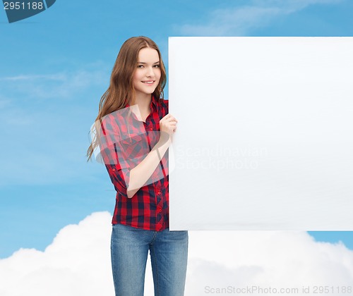 Image of smiling young teenage girl with white blank board