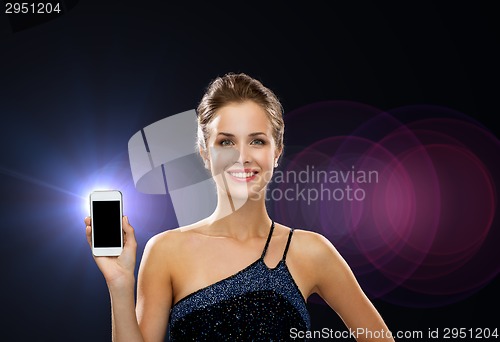 Image of smiling woman in evening dress with smartphone