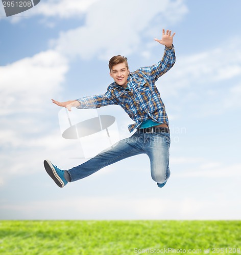 Image of smiling young man jumping in air