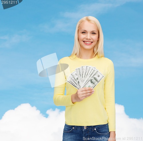 Image of smiling girl with dollar cash money