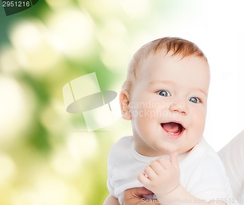 Image of close up of mother holding smiling baby