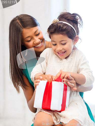 Image of happy mother and child girl with gift box