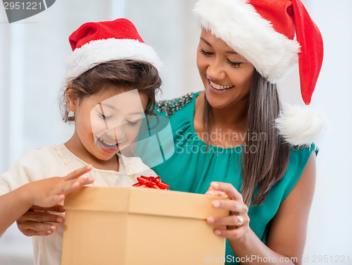 Image of happy mother and child girl with gift box