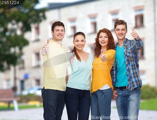 Image of group of smiling teenagers over campus background