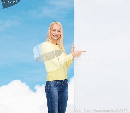 Image of smiling woman in sweater with blank white board