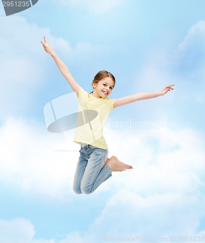 Image of smiling little girl jumping