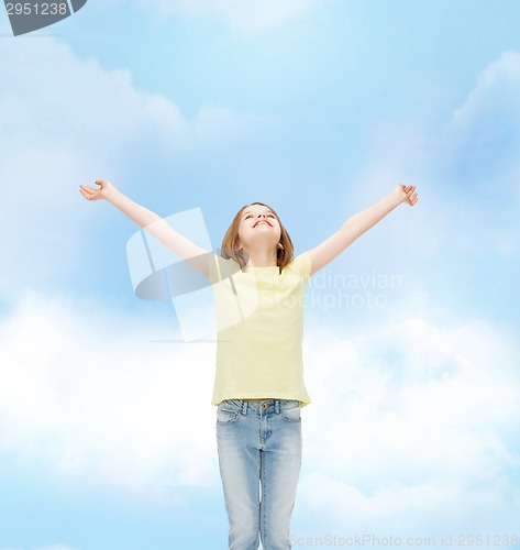 Image of smiling teenage girl with raised hands