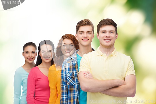 Image of group of smiling teenagers over green background