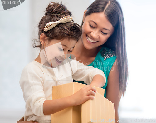 Image of happy mother and child girl with gift box