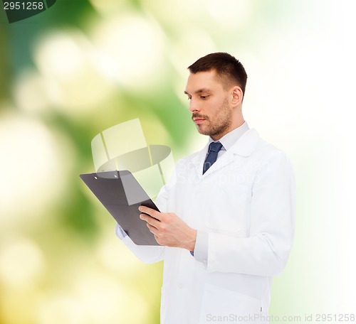 Image of serious male doctor with clipboard