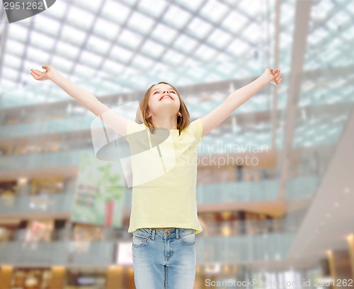 Image of smiling teenage girl with raised hands