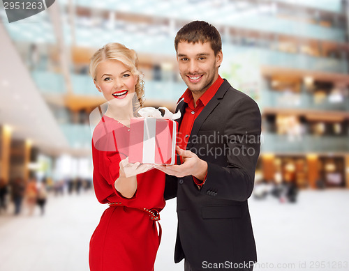 Image of smiling man and woman with present
