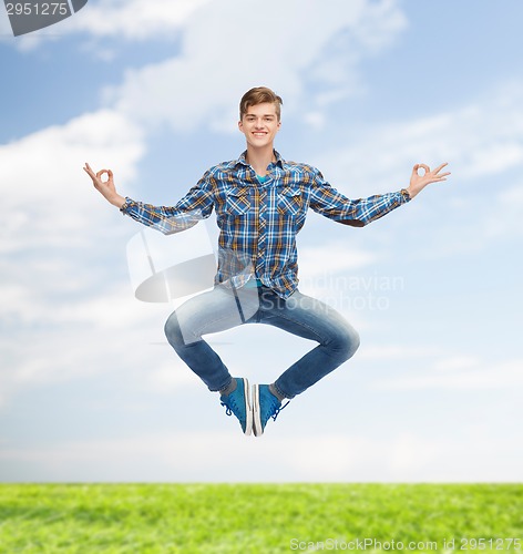 Image of smiling young man jumping in air