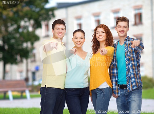 Image of group of smiling teenagers over campus background