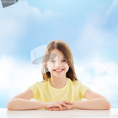 Image of beautiful little girl sitting at table