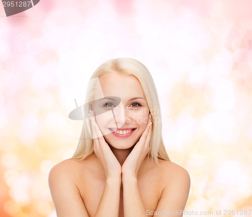 Image of beautiful woman touching her face skin