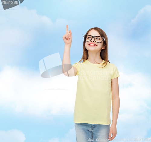 Image of smiling cute little girl in black eyeglasses