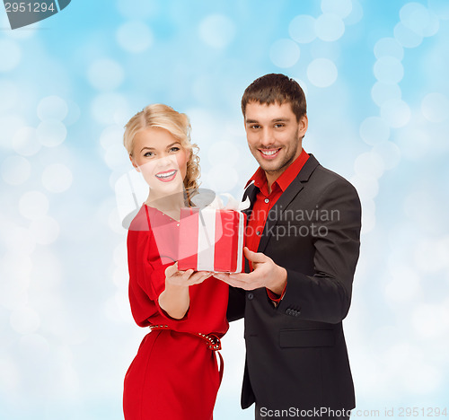 Image of smiling man and woman with present