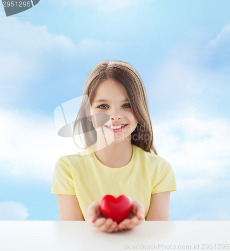 Image of beautiful little girl sitting at table