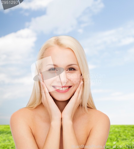 Image of beautiful woman touching her face skin