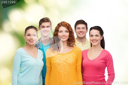 Image of group of smiling teenagers over green background