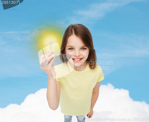 Image of smiling little girl holding light bulb