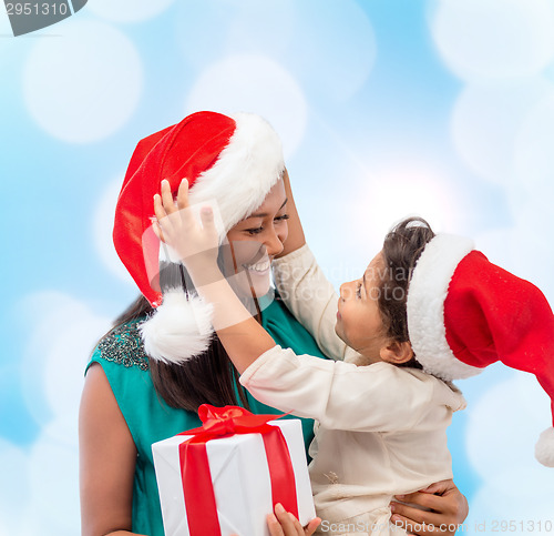 Image of happy mother and child girl with gift box