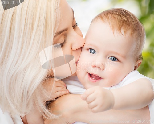 Image of happy mother kissing smiling baby
