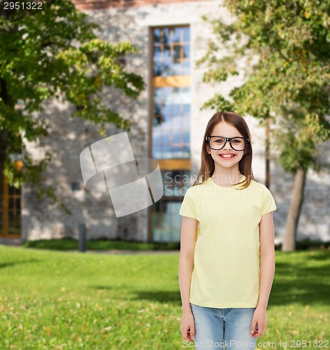 Image of smiling cute little girl in black eyeglasses